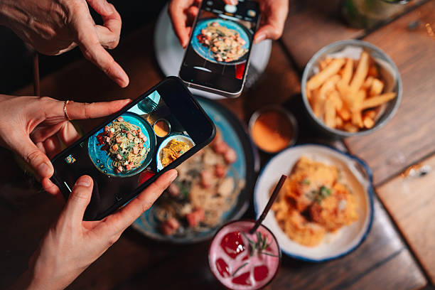 Friends capturing content of food at a cafe