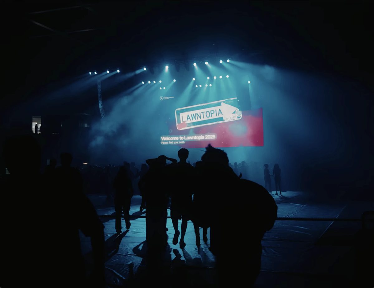 Students walking into the arena under the Lawntopia 2025 welcome screen